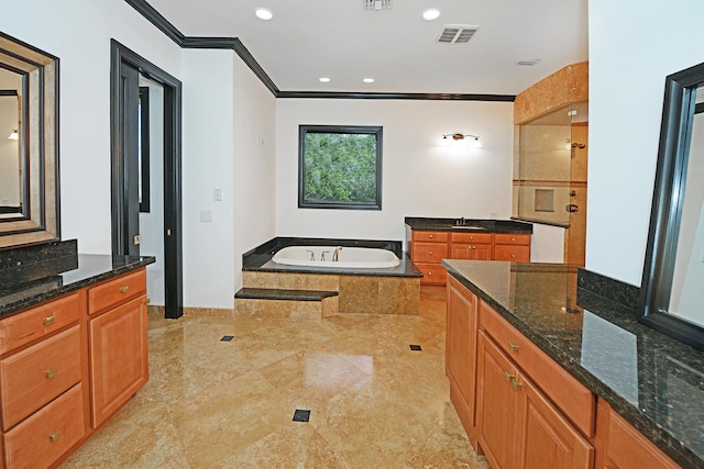 bathroom with vanity, a relaxing tiled tub, and crown molding