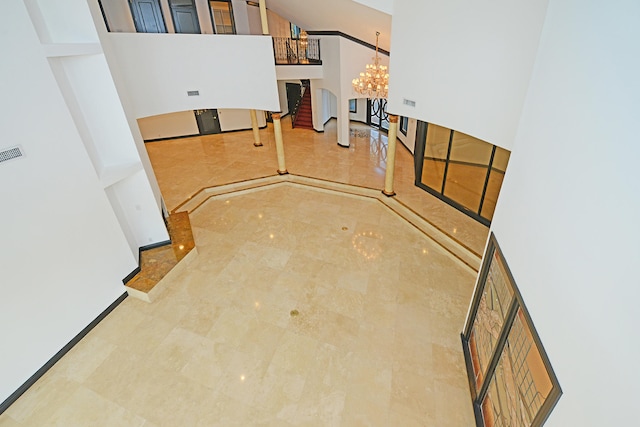 interior space featuring an inviting chandelier and a towering ceiling