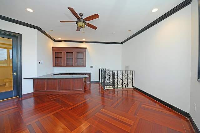 kitchen with kitchen peninsula, dark parquet floors, ceiling fan, and crown molding