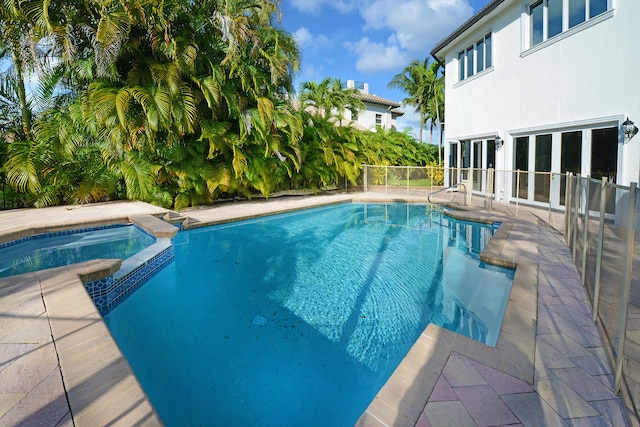 view of swimming pool with an in ground hot tub