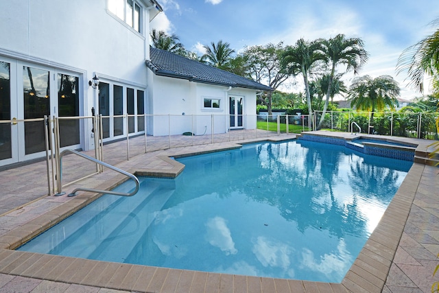 view of swimming pool featuring an in ground hot tub and a patio