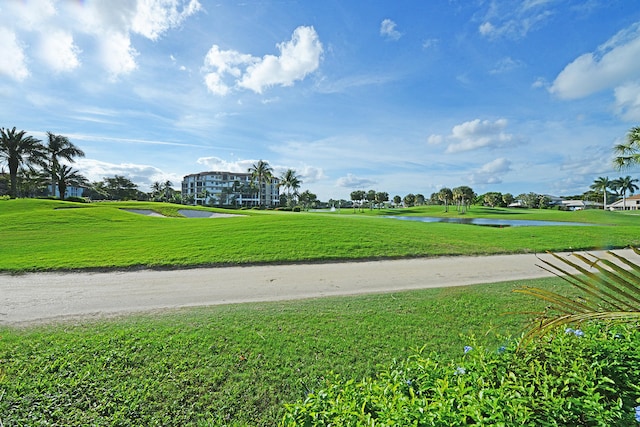 view of home's community featuring a lawn and a water view