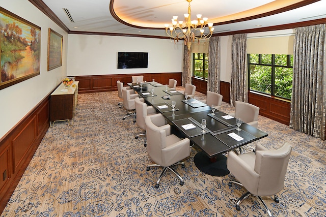 dining room with a tray ceiling, ornamental molding, and an inviting chandelier