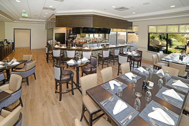 dining area featuring light hardwood / wood-style floors and crown molding