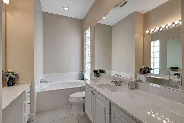 bathroom with tile patterned flooring, vanity, a bathtub, and toilet