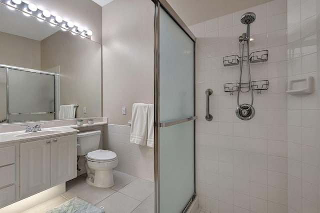 bathroom with tile patterned flooring, vanity, toilet, and walk in shower