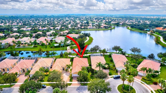 drone / aerial view featuring a residential view and a water view