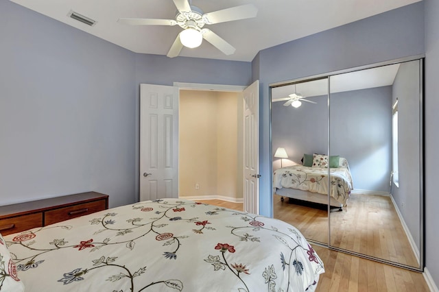 bedroom with wood-type flooring, a closet, and ceiling fan