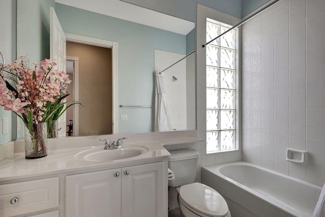 full bathroom with vanity, toilet, and tiled shower / bath