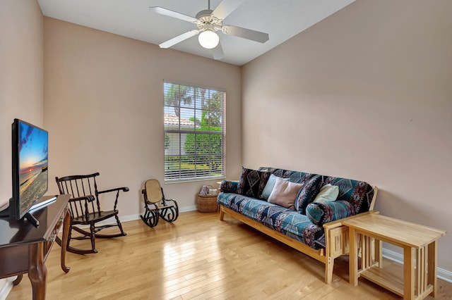 living area featuring ceiling fan and light hardwood / wood-style flooring