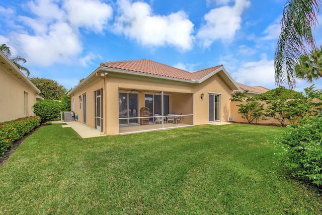 back of house with a yard, central AC unit, and a sunroom