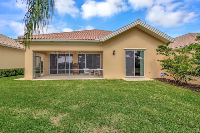 back of house featuring a patio area, ceiling fan, a lawn, and stucco siding