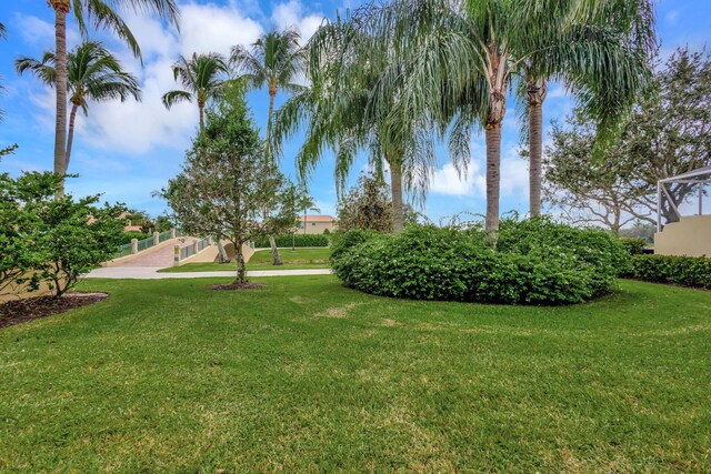 back of property with a ceiling fan, a lawn, a sunroom, a patio area, and stucco siding