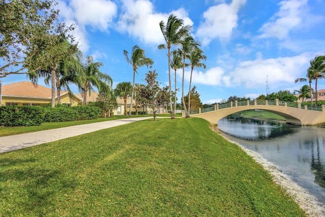 view of community featuring a yard and a water view