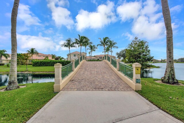 view of property's community featuring a water view and a yard