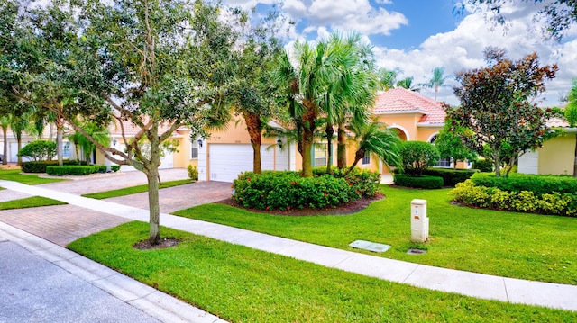 view of front of property with a garage and a front yard