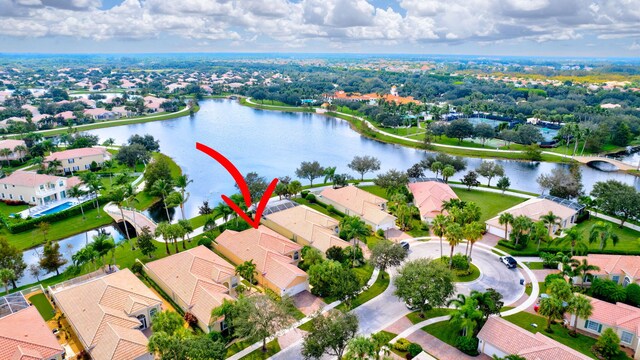 drone / aerial view featuring a water view and a residential view