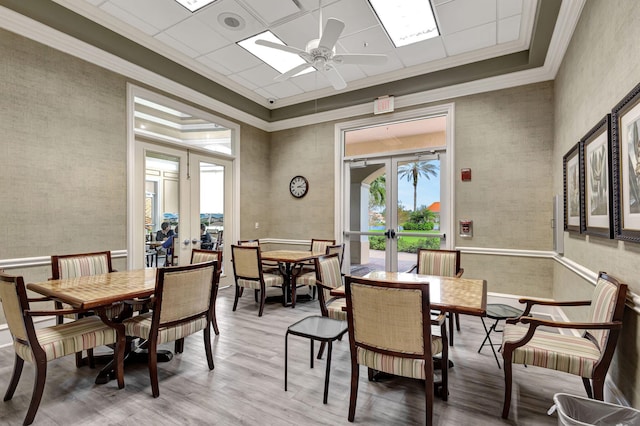 dining space with french doors, ceiling fan, and wood-type flooring