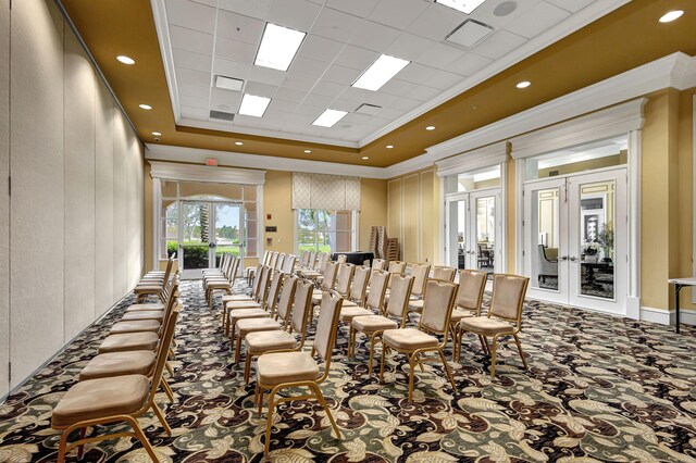 dining area featuring carpet floors, visible vents, a tray ceiling, and a decorative wall