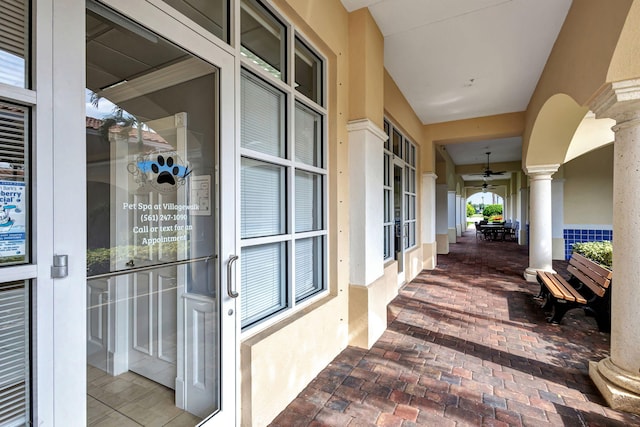 exterior space with ceiling fan