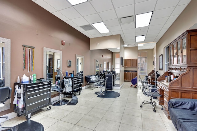 interior space featuring a drop ceiling and light tile patterned floors