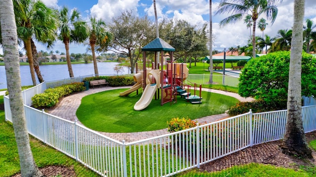 view of playground with a water view and a yard