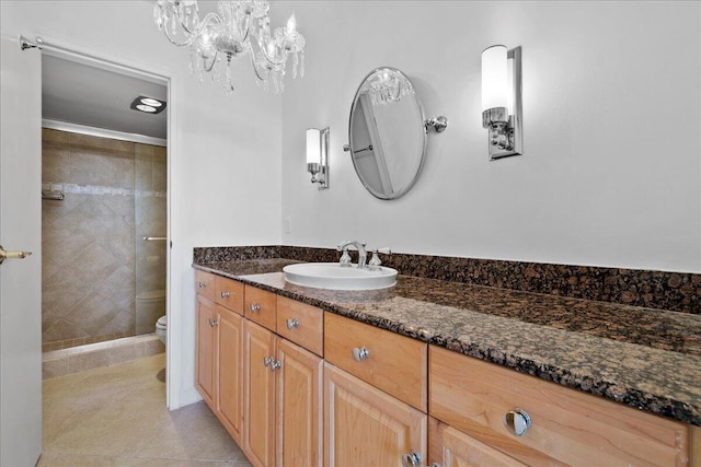 bathroom with vanity, an inviting chandelier, tile patterned flooring, toilet, and an enclosed shower