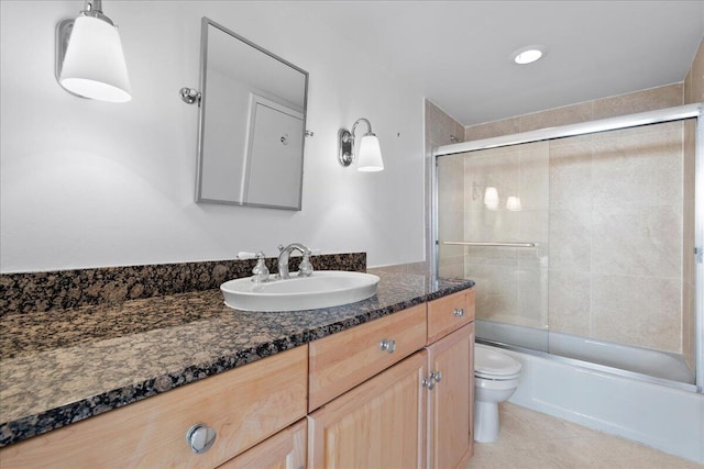 full bathroom with shower / bath combination with glass door, tile patterned floors, vanity, and toilet