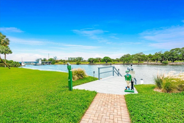 view of dock with a water view and a yard