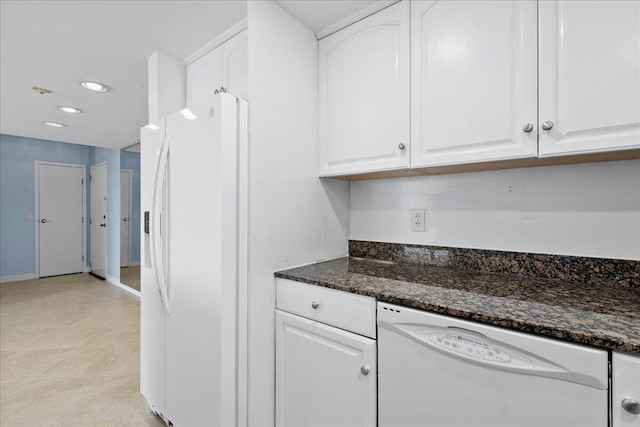 kitchen featuring white cabinets, dark stone countertops, white appliances, and light tile patterned floors