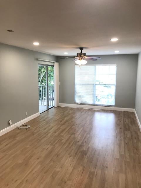 empty room with ceiling fan and wood-type flooring