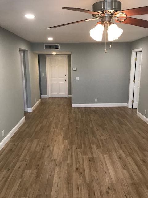 spare room featuring ceiling fan and dark hardwood / wood-style flooring