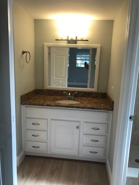 bathroom featuring vanity and hardwood / wood-style flooring