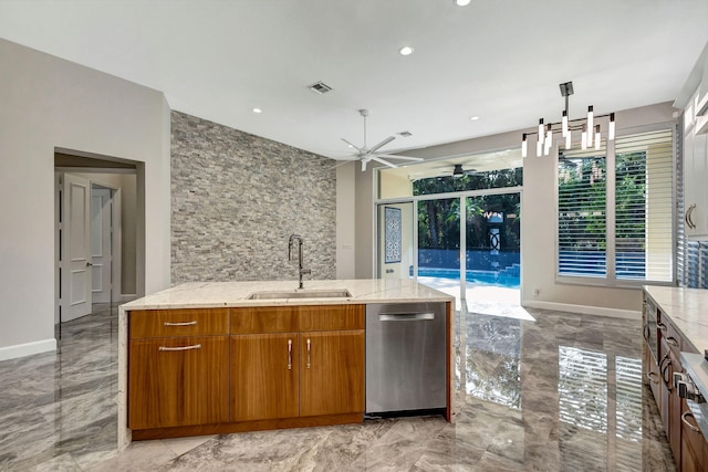 kitchen with dishwasher, ceiling fan with notable chandelier, sink, hanging light fixtures, and light stone countertops