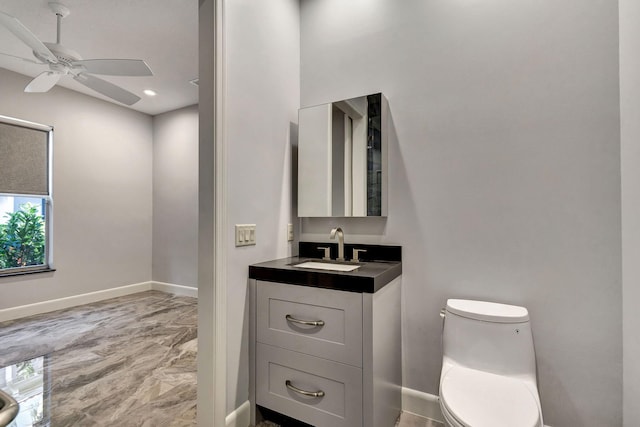 bathroom with vanity, toilet, and ceiling fan