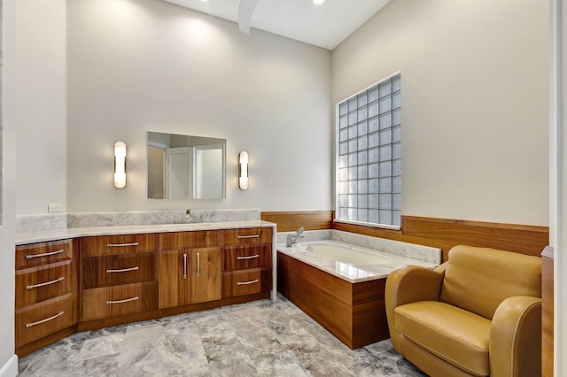 bathroom with a washtub, vanity, and wooden walls