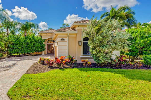 mediterranean / spanish-style home featuring a front lawn