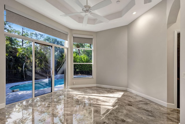 unfurnished room with a tray ceiling and ceiling fan