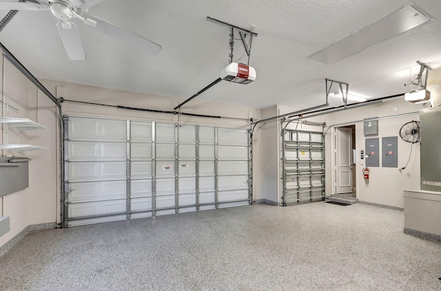 garage with electric panel, ceiling fan, and a garage door opener