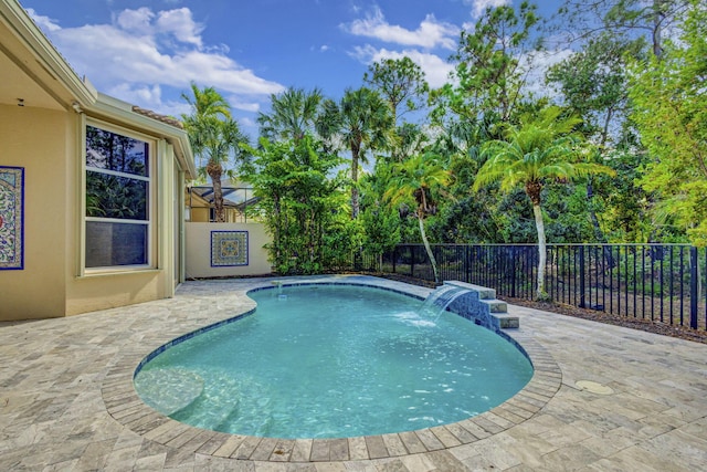 view of swimming pool with pool water feature and a patio