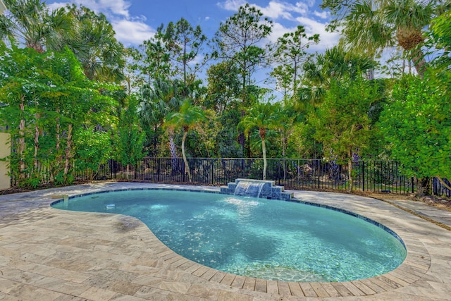 view of pool with pool water feature and a patio area