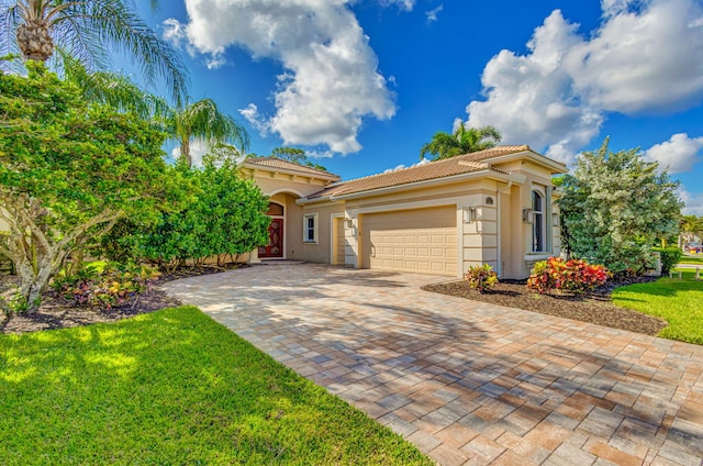 mediterranean / spanish-style home with a garage and a front lawn