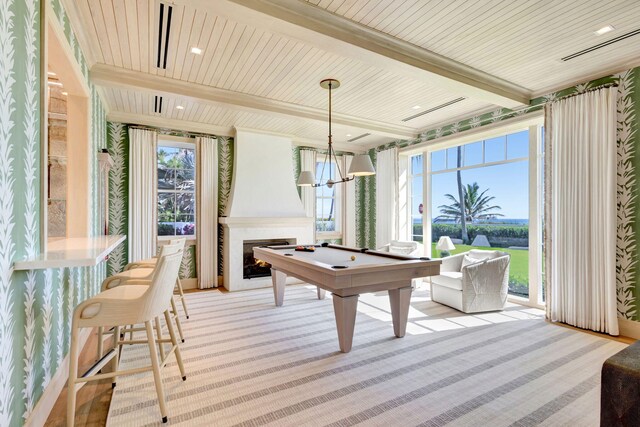 playroom with billiards, plenty of natural light, beamed ceiling, a large fireplace, and light carpet