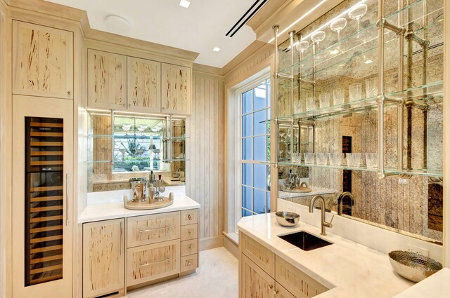 full bathroom with wine cooler, plenty of natural light, and vanity