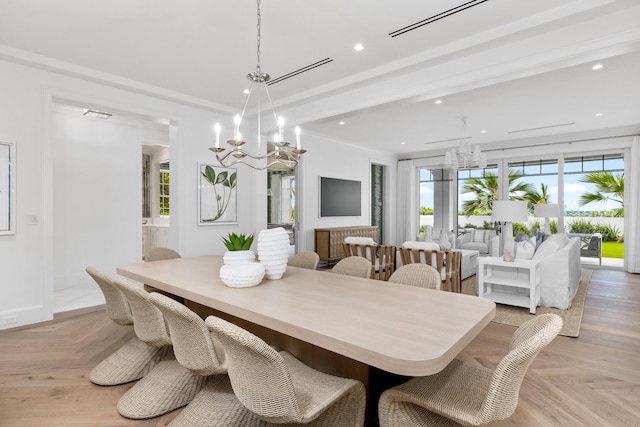 dining room featuring crown molding, a notable chandelier, and light parquet floors