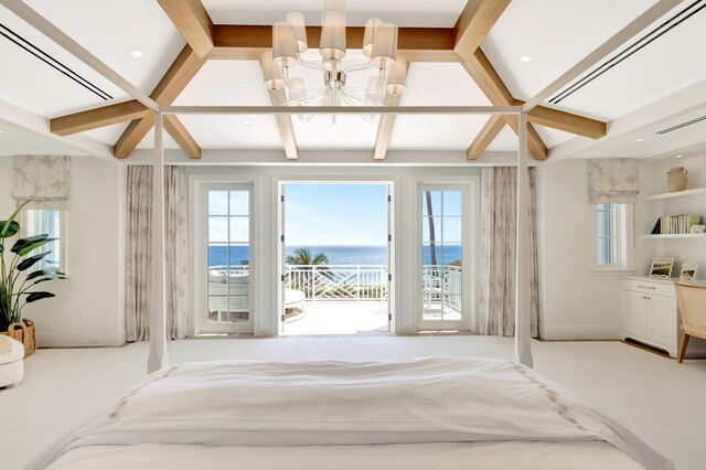 unfurnished bedroom with a water view, a chandelier, access to outside, and multiple windows