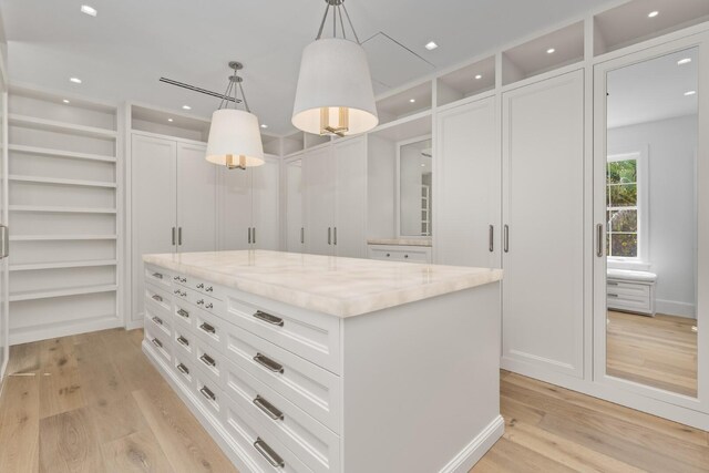 walk in closet featuring light wood-style flooring