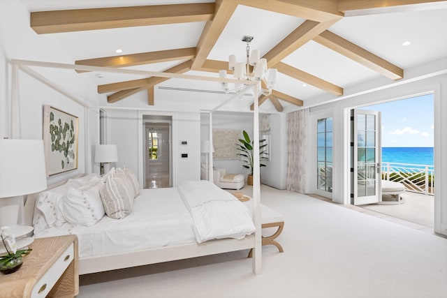 carpeted bedroom with access to exterior, multiple windows, a water view, and ceiling fan with notable chandelier