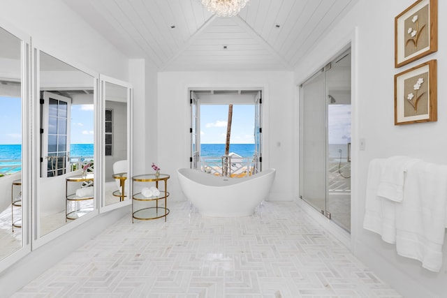 bathroom with vaulted ceiling with beams, independent shower and bath, wooden ceiling, and a water view