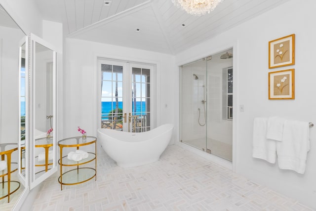 bathroom with separate shower and tub, vaulted ceiling, wood ceiling, and a water view